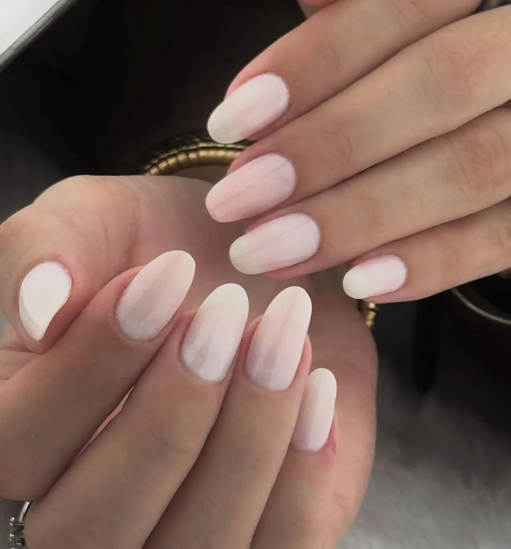 Unhas amendoadas em branco leitoso, vistas de perto